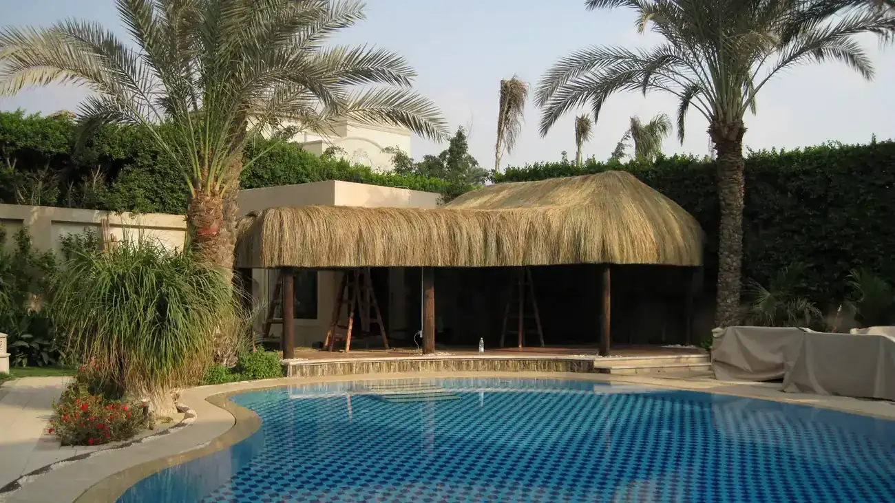 Thatched cabanas beside a pool