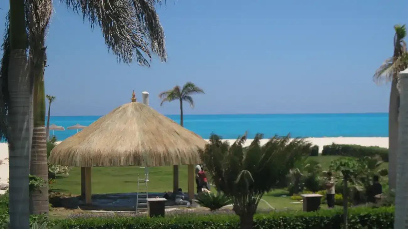 Thatched gazebo by a turquoise bay